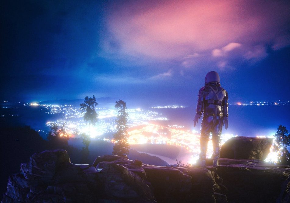 man standing on rock formation during night time